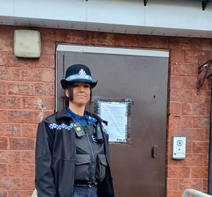 A police officer stands outside the shut down property