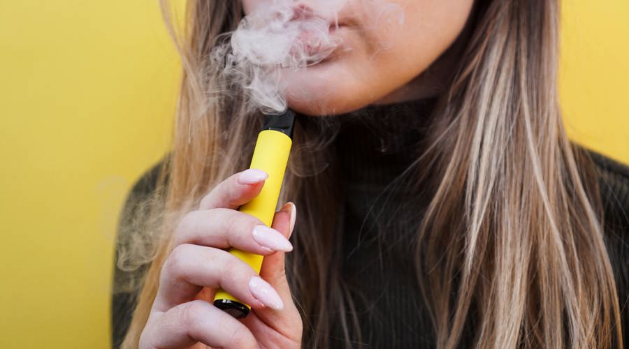 A young person using a vape
