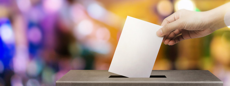 A ballot paper being placed in a ballot box