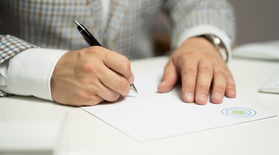 A man signing a tenancy agreement