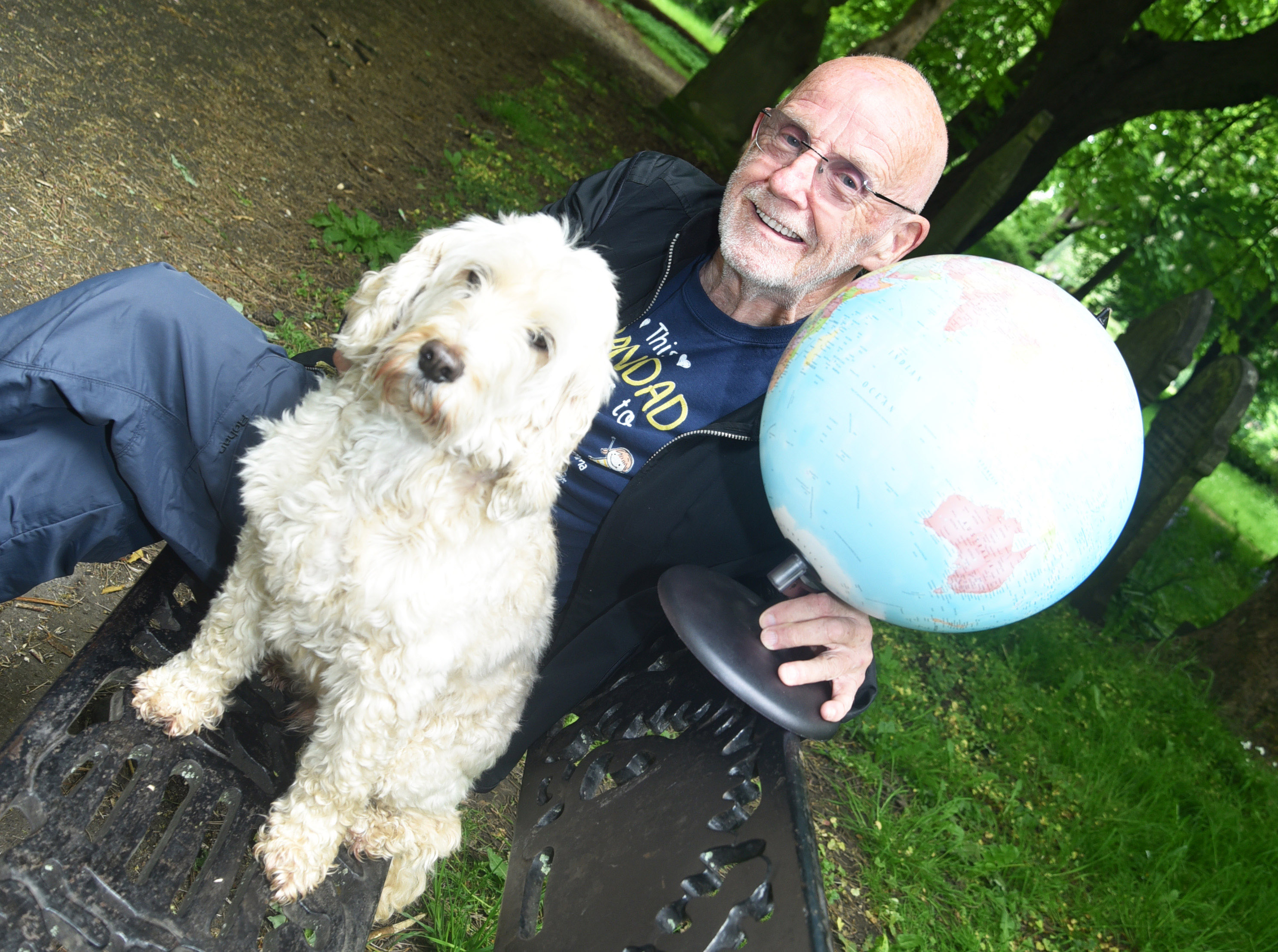 Ian with a globe and his dog in Albert Park